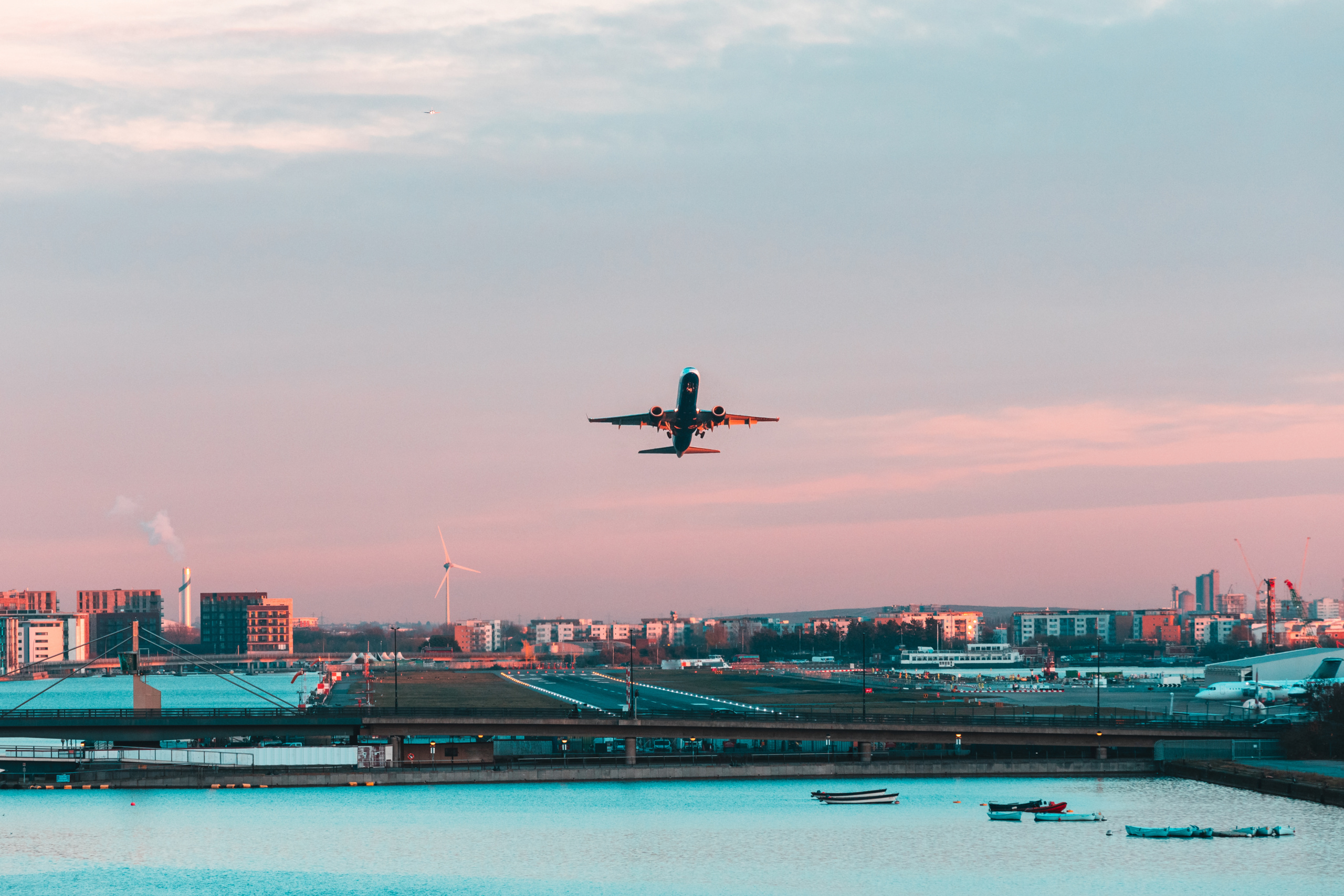 Airplane taking off from London city airport at sunset